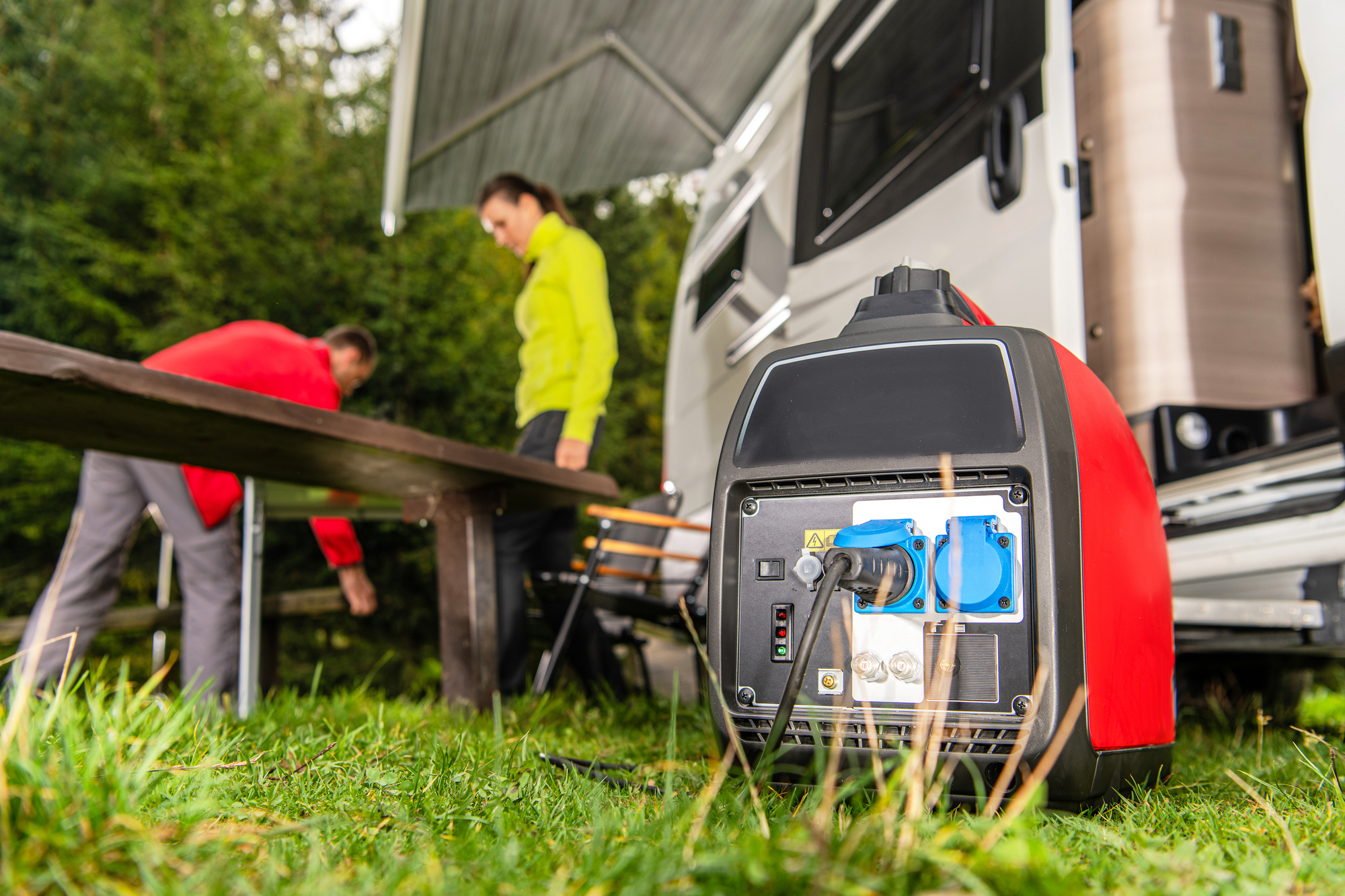 Small RV generator with coupe in the background